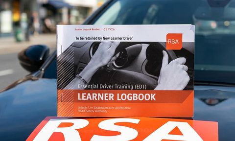 EDT learner logbook standing on an RSA driving school car